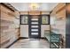 Mudroom with a modern front door, neutral accent wall, and a green bench at 142 High Point Dr, Breckenridge, CO 80424