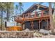 Beautiful exterior with hot tub, deck and walkout patio with lush landscaping at 142 High Point Dr, Breckenridge, CO 80424