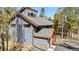Exterior view of home featuring wood accents, balcony, and lush landscaping at 142 High Point Dr, Breckenridge, CO 80424