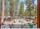Stone fire pit with outdoor seating and forest views from the patio at 142 High Point Dr, Breckenridge, CO 80424