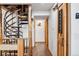 Hallway with a spiral staircase, wood accents, barn door for the pantry, and wood flooring at 142 High Point Dr, Breckenridge, CO 80424