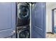 Convenient laundry closet with stacked washer and dryer, and stylish blue doors at 142 High Point Dr, Breckenridge, CO 80424