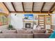 Cozy living room features a stone fireplace, beamed ceilings, and comfortable seating at 142 High Point Dr, Breckenridge, CO 80424