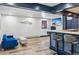 Open-concept living room with a sofa, bar with stools, and mountain decor at 142 High Point Dr, Breckenridge, CO 80424