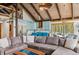 Open-concept living room showcasing a modern kitchen, comfortable seating and vaulted ceilings with exposed wooden beams at 142 High Point Dr, Breckenridge, CO 80424