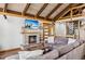 Relaxing living room with stone fireplace, TV, spiral staircase, and comfortable sofa at 142 High Point Dr, Breckenridge, CO 80424