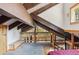 Loft area overlooking trees, with wooden beams and railings at 142 High Point Dr, Breckenridge, CO 80424