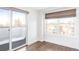 Bright bedroom with hardwood floors, sliding door to private balcony, and treetop views at 419 Harrison St, Denver, CO 80206