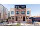 Modern brick three-unit building with two-car garage and landscaped yards at 419 Harrison St, Denver, CO 80206