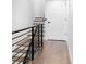 Modern staircase with black railing and hardwood floors at 419 Harrison St, Denver, CO 80206