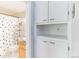 Hall bathroom with built-in storage and adjacent toilet and shower at 1182 Clermont St # A202, Denver, CO 80220