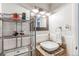 Bathroom featuring a granite countertop, a vessel sink, and decorative mirror with mosaic tile accents at 1182 Clermont St # A202, Denver, CO 80220