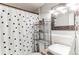 Cozy bathroom featuring a patterned shower curtain, a decorative mirror, and a stylish vessel sink at 1182 Clermont St # A202, Denver, CO 80220
