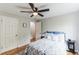 Cozy bedroom featuring a ceiling fan, hardwood floors, and a comfortable bed with stylish bedding at 1182 Clermont St # A202, Denver, CO 80220