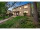 Two-story brick apartment building featuring manicured landscaping at 1182 Clermont St # A202, Denver, CO 80220
