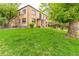 Charming brick building with a lush green lawn and mature trees, providing a serene outdoor setting at 1182 Clermont St # A202, Denver, CO 80220