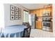 Cozy kitchen with wooden cabinetry, modern stainless steel appliances, and a dining area at 1182 Clermont St # A202, Denver, CO 80220