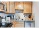 Updated kitchen with stainless steel appliances, granite countertops, tile backsplash, and light-toned cabinetry at 1182 Clermont St # A202, Denver, CO 80220