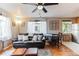 Well-lit living room showcasing hardwood floors, a black sofa, and natural light, offering a welcoming area at 1182 Clermont St # A202, Denver, CO 80220