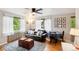 Bright living room featuring hardwood floors, large windows with sheer curtains, and contemporary furnishings at 1182 Clermont St # A202, Denver, CO 80220