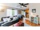 Open-concept living area featuring hardwood floors, a comfortable sofa, and a seamless flow to the kitchen at 1182 Clermont St # A202, Denver, CO 80220
