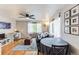 Bright living room with hardwood floors, a modern workspace, and comfortable seating arrangements at 1182 Clermont St # A202, Denver, CO 80220