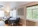 Comfortable living space featuring hardwood floors, a round dining table, and ample natural light from large windows at 1182 Clermont St # A202, Denver, CO 80220