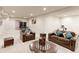 Open basement area with comfortable seating, table and gym equipment, offering space for relaxation and fitness at 2065 E 150Th Pl, Thornton, CO 80602