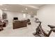 Spacious basement with gym equipment, comfortable seating, and recessed lighting providing versatile living space at 2065 E 150Th Pl, Thornton, CO 80602