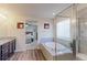 Bathroom featuring vanity, bathtub, and view into bedroom at 2065 E 150Th Pl, Thornton, CO 80602