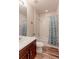 Clean bathroom with a shower-tub combo, modern fixtures, and a tasteful blue curtain providing a comfortable design at 2065 E 150Th Pl, Thornton, CO 80602