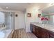 Bathroom features double vanity, walk-in shower, and soaking tub at 2065 E 150Th Pl, Thornton, CO 80602