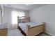 Comfortable bedroom with a decorative headboard, soft carpet and natural light creating a peaceful retreat at 2065 E 150Th Pl, Thornton, CO 80602