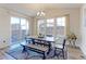 Bright dining room features a large table, modern chandelier, and sliding glass doors at 2065 E 150Th Pl, Thornton, CO 80602