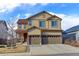 Charming two-story home boasts a three-car garage and a beautifully maintained front yard at 2065 E 150Th Pl, Thornton, CO 80602