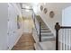 Inviting foyer with a soaring ceiling, staircase, and wood-look floors creates a grand entrance at 2065 E 150Th Pl, Thornton, CO 80602