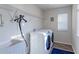 Efficient laundry room featuring modern appliances, ample shelving, and natural light for a functional space at 2065 E 150Th Pl, Thornton, CO 80602