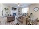 Cozy living room with a fireplace, large window, and comfortable seating creates a relaxing atmosphere at 2065 E 150Th Pl, Thornton, CO 80602