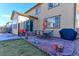 Inviting backyard patio featuring outdoor dining furniture, a grill, and views of the lawn, ideal for entertaining at 2065 E 150Th Pl, Thornton, CO 80602