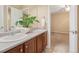 Bright bathroom features double sinks, natural light, decorative plants, and easy access to the bedroom at 13744 W 86Th Dr, Arvada, CO 80005