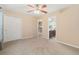 Spacious bedroom offers plush carpeting, a ceiling fan, and convenient access to the en-suite bathroom at 13744 W 86Th Dr, Arvada, CO 80005