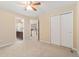 Bedroom features plush carpet, a ceiling fan and convenient access to the en-suite bathroom and hallway at 13744 W 86Th Dr, Arvada, CO 80005