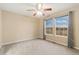 Bright bedroom featuring neutral carpet, two windows for natural light, and contemporary curtains at 13744 W 86Th Dr, Arvada, CO 80005