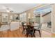 Bright dining area with a round table, hardwood floors, and sliding doors to outdoor space at 13744 W 86Th Dr, Arvada, CO 80005