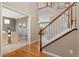 Welcoming entryway featuring hardwood floors, staircase, and formal dining room at 13744 W 86Th Dr, Arvada, CO 80005