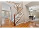 Home entryway featuring hardwood floors, staircase and view into the living and dining room at 13744 W 86Th Dr, Arvada, CO 80005
