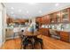 Open kitchen with cherry cabinets, stainless steel appliances, and a breakfast bar with seating at 13744 W 86Th Dr, Arvada, CO 80005