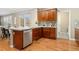 Well-lit kitchen with stainless steel appliances, wood cabinets, and adjacent living space at 13744 W 86Th Dr, Arvada, CO 80005