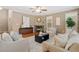 Well-appointed living room featuring neutral tones, fireplace, and abundant natural light at 13744 W 86Th Dr, Arvada, CO 80005