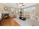Cozy living room showcasing hardwood floors, a fireplace, and comfortable seating at 13744 W 86Th Dr, Arvada, CO 80005